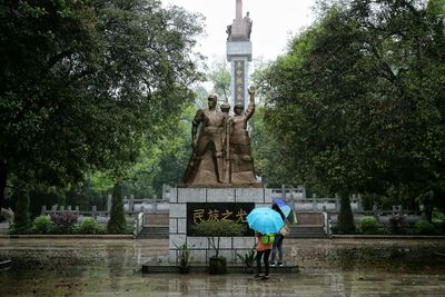 Statue in park during rainy season