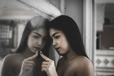 Portrait of young woman holding camera