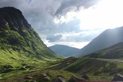 Scenic view of mountains against cloudy sky