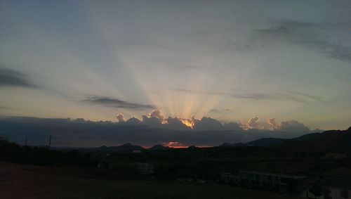 Scenic view of mountains against sky at sunset