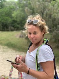 Portrait of woman holding mobile phone