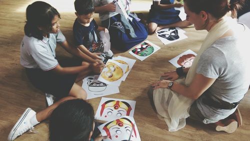 High angle view of people sitting on floor