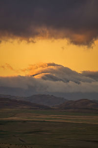 Scenic view of field against sky during sunset