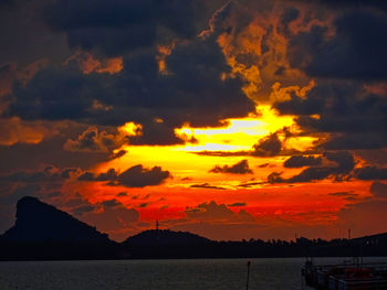 Scenic view of dramatic sky over sea during sunset