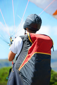 Rear view of man holding umbrella