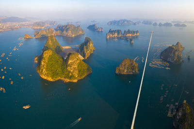 High angle view of rocks by sea against sky