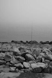 Rocks on beach against sky