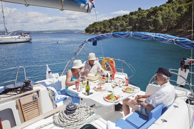 Senior people having lunch on boat