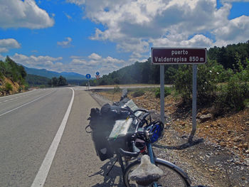 Road sign against sky