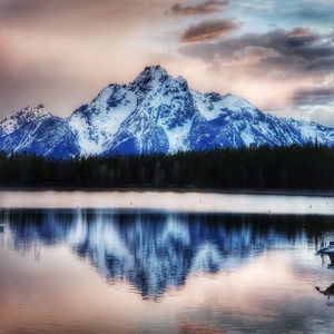 Scenic view of lake and snowcapped mountains against sky