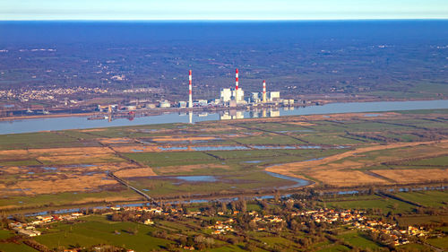 High angle view of townscape by sea against sky