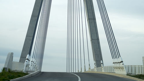 Low angle view of bridge against sky in city