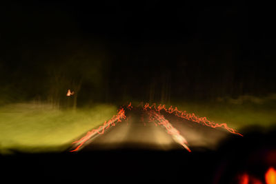 Close-up of illuminated lights in the dark