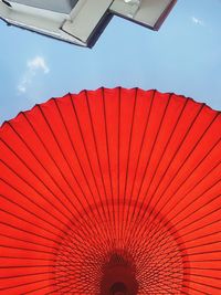 Low angle view of red umbrella against sky