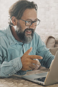 Senior man using laptop at home