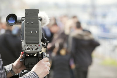 Close-up of man photographing camera