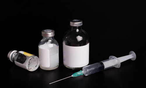 Close-up of bottles against black background