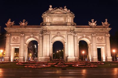 Low angle view of illuminated building at night 