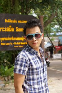 Portrait of man wearing sunglasses while standing outdoors