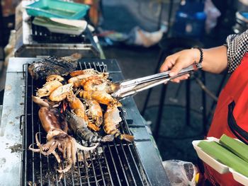 Man preparing food on barbecue grill