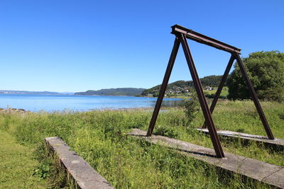 Scenic view of field against clear blue sky