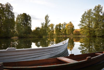 Boat moored in lake against sky