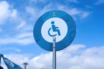 Low angle view of road sign against sky