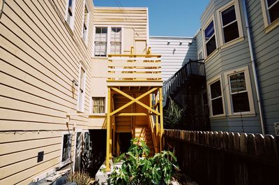 Low angle view of yellow buildings against sky