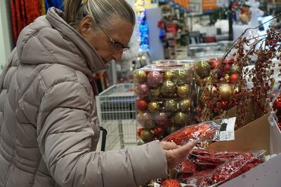 Midsection of woman holding food at market