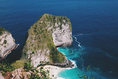 High angle view of rock formations by sea