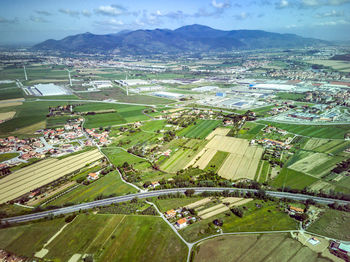 High angle view of cars on field by buildings