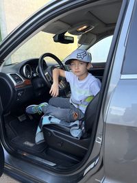 High angle view of man sitting in car jeep