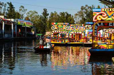 Boats in river against sky