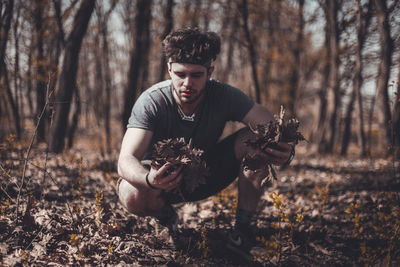 Portrait of young man in forest