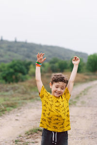 A six-year-old boy runs in the countryside.