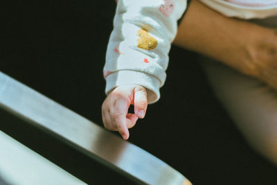 Low section of woman holding hands