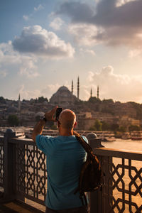 Rear view of man looking at city buildings