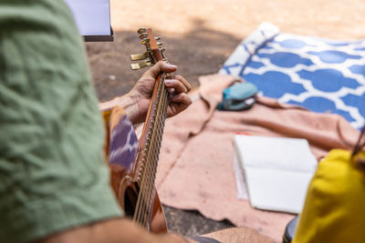 Cropped hand of man playing guitar