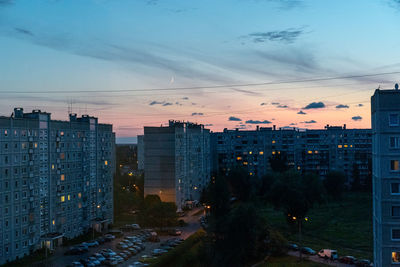 High angle view of illuminated buildings against sky at sunset