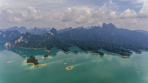 Aerial view of lake and mountains against sky