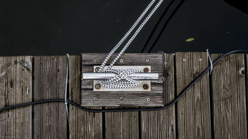 High angle view of information sign on wooden wall