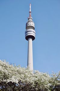 Low angle view of communications tower against sky