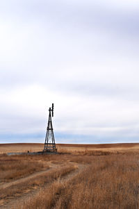 Windmill on field against sky