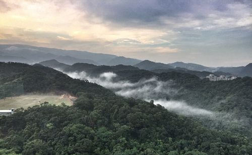 Scenic view of mountains against cloudy sky