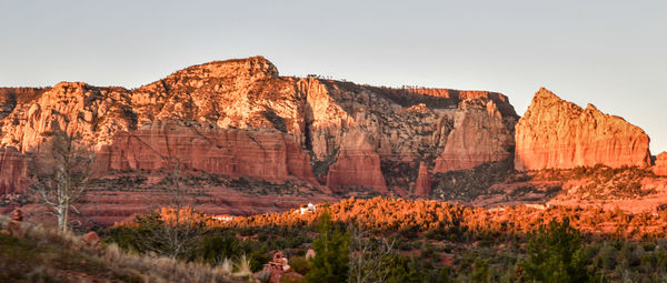 Rock formations on mountain against clear sky