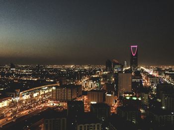 High angle view of illuminated buildings against sky at night