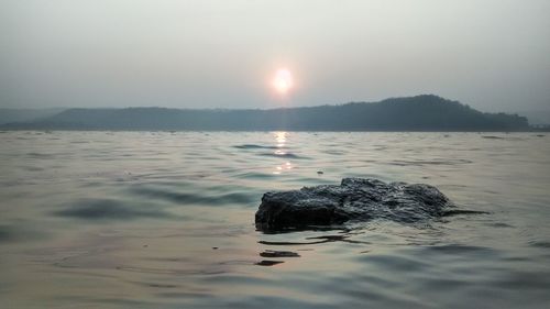 Scenic view of sea against clear sky during sunset