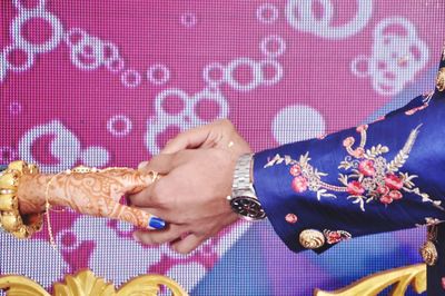 Cropped hand of couple exchanging wedding ring