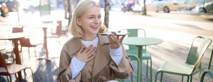 Portrait of young woman using mobile phone