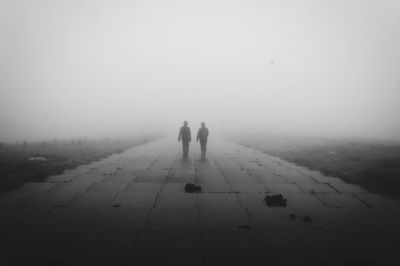 People walking on steps in foggy weather